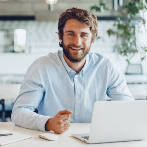 White bearded man Businessman in shirt working on his laptop in an office