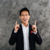 Portrait of a happy young asian man dressed in suit